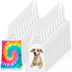 a dog sitting next to a bag with a tie - dye photo on it and the bags are white