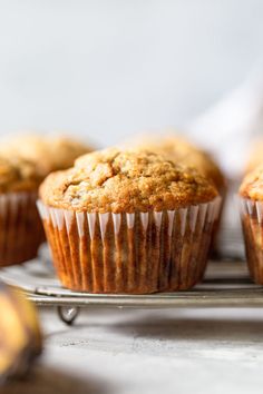 several muffins sitting on top of a white cloth next to each other in a wooden tray