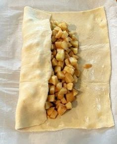 an uncooked pastry with apples on it