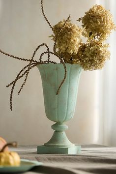 a vase filled with flowers sitting on top of a table