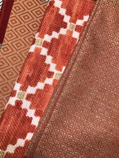 three pieces of fabric with different patterns and colors are shown in close up on the surface