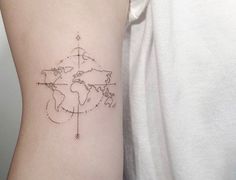 a woman's arm with a world map tattoo on the left side of her body