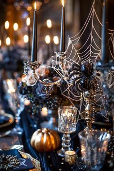 a table topped with lots of candles and spider webs on top of each other