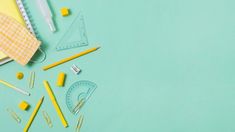 school supplies laid out on top of a blue surface with scissors, rulers and pencils