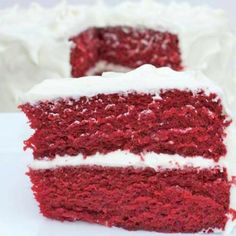 a slice of red velvet cake with white frosting