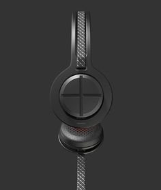 the black headphones are on display against a dark background with red dots and lines