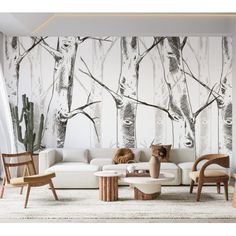 a living room with white furniture and wallpaper