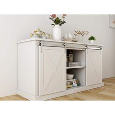 a white cabinet with sliding doors and flowers on top