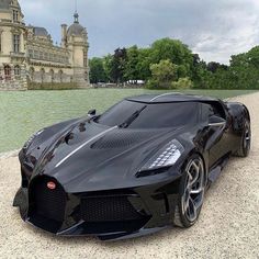 a black sports car parked in front of a building