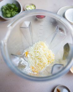 a blender filled with cheese and other ingredients