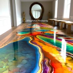 the floor is painted with multicolors and there are candles on it in front of a mirror