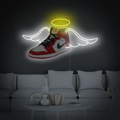 a pair of sneakers is lit up with neon lights in the living room, along with pillows and a coffee table