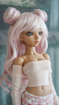 a doll with pink hair and blue eyes