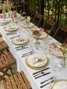 a long table set with plates and silverware