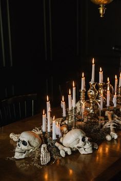 a table topped with lots of candles and skulls