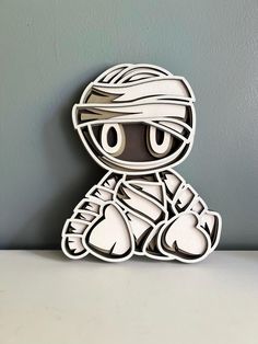 a paper cut out of a cartoon character sitting on top of a white countertop