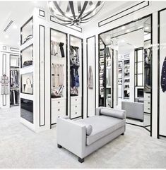 a white room with mirrored walls and lots of closet space