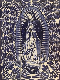 an image of the virgin mary in blue and white tiles