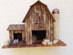 a wooden shelf with a barn on it