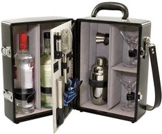 an open suitcase with bottles and glasses in it on a white background, showing the contents inside