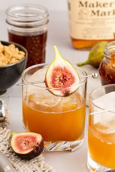 two glasses filled with liquid and some sliced figs