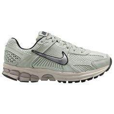 the nike air zoom running shoe is light green and has a white upper with black accents