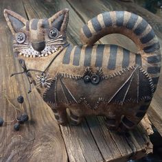 a cat statue sitting on top of a wooden table