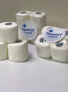 several rolls of toilet paper sitting next to each other on a white counter top,