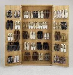 a wooden shoe rack filled with lots of shoes