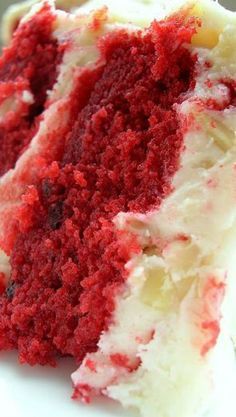 a slice of red velvet cake with white frosting