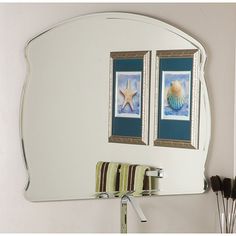 a bathroom mirror that has two pictures on it