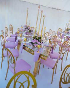 a dining room set up with purple and gold chairs