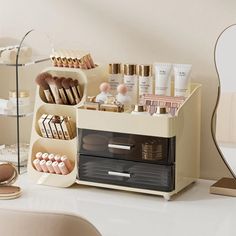 an assortment of cosmetics and makeup products displayed on a white table with a mirror in the background