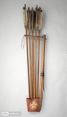 an arrow and bow holder with arrows in it