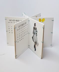 an open calendar book with the image of a woman in a white dress on it