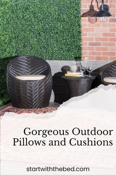 two outdoor pillows and cushions sitting on top of a table