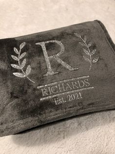 a personalized towel with the initials and date on it