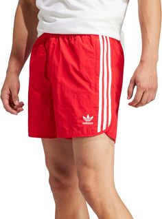 Fit & Design Regular fit track shorts Split side hem offers unrestricted movement Drawcord on elastic waist Fabric has a lightweight, comfortable feel Two side zip pockets and one back pocket Design inspired by the adidas® archives Iconic 3-Stripes down the side Embroidered Trefoil on left thigh Additional Details Made with 100% recycled materials Summer Sportswear Bottoms With Three Stripes, Adidas Nylon Activewear, Casual Adidas Logo Shorts, Adidas Athleisure Nylon Activewear, Adidas Activewear Sportswear, Adidas Athleisure Activewear For Summer, Sportswear Bottoms With Three Stripes For Summer, Three Stripes Sportswear Bottoms For Summer, Three Stripes Branding Sportswear For Summer