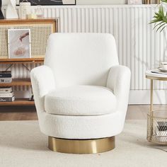 a white chair with a gold base in a living room