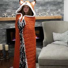 a woman in an orange crocheted fox blanket