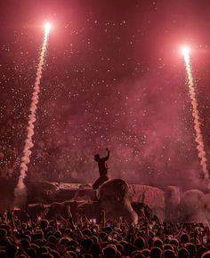 a man riding on the back of an elephant in front of fireworks