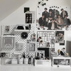 a white desk topped with lots of pictures and magnets