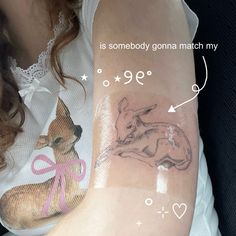 a woman's arm with tattoos on it and an image of a dog in the background