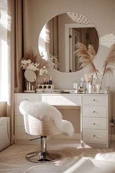 a white vanity with a mirror and stool