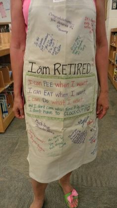 a woman in a white apron with words written on it and saying i am retired