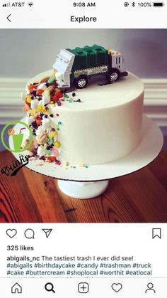 a white cake with a train on top and sprinkles all over it