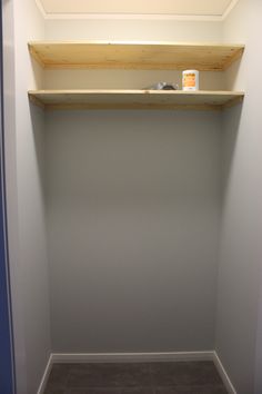 the corner of a room with a shelf above it