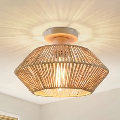 a bamboo light fixture hanging from the ceiling