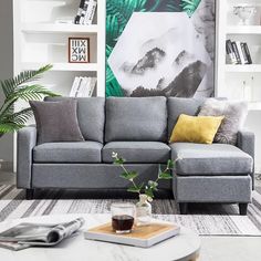 a living room filled with furniture and a large painting on the wall behind it's couch