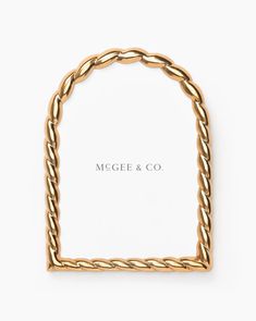 a gold rope frame with the word mega & co on it